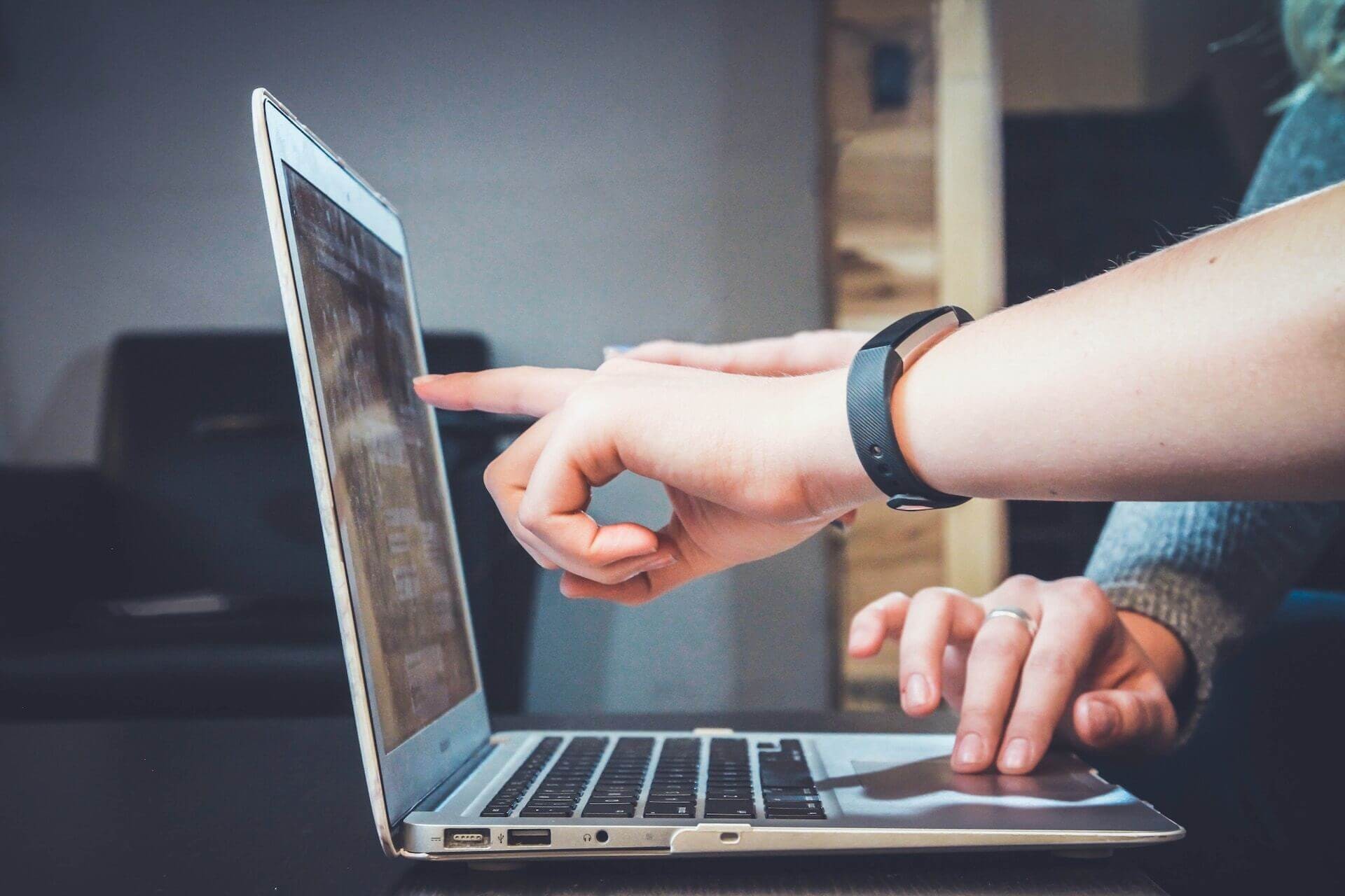 working together and looking at the screen of the laptop